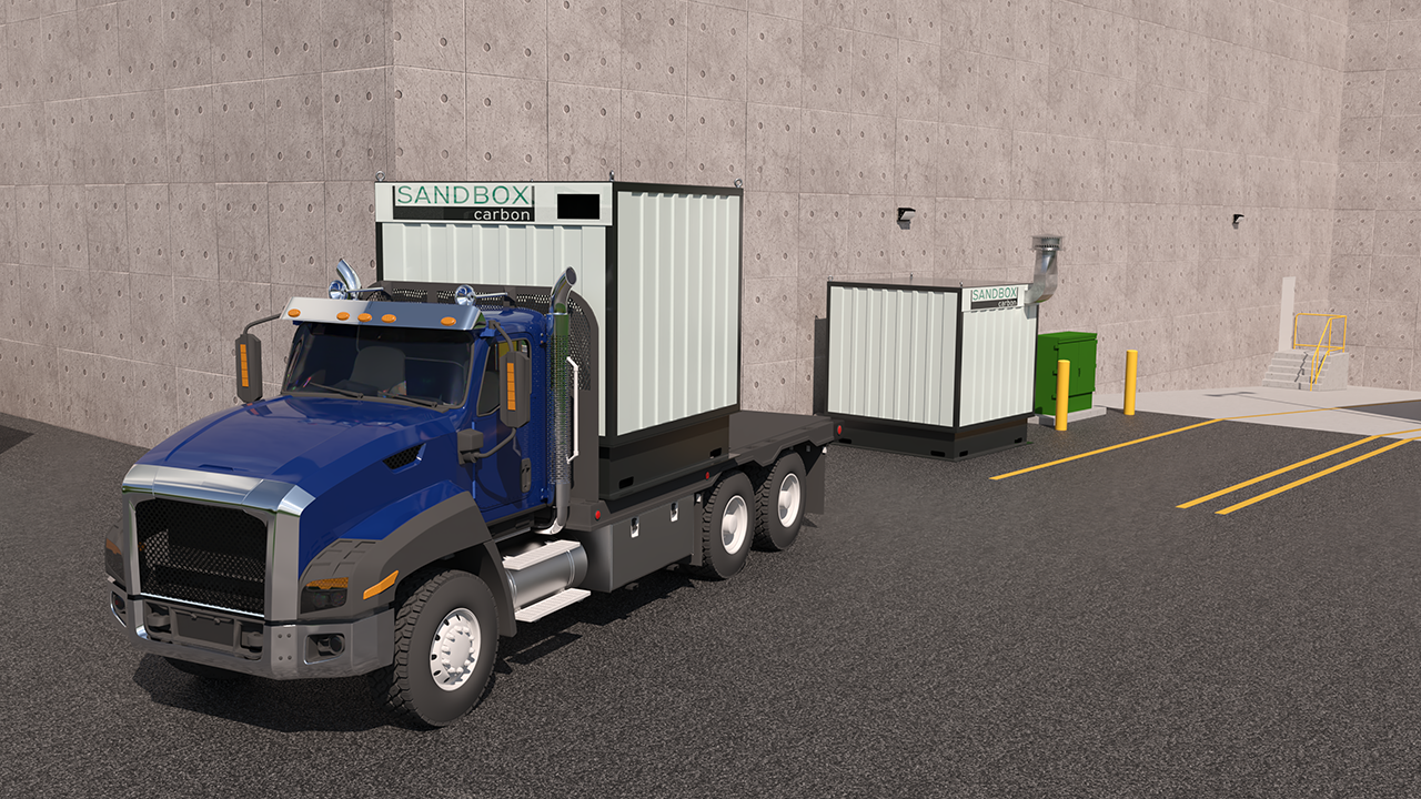 A truck dropping off an empty Carbon Dumpster and picking up a full one.